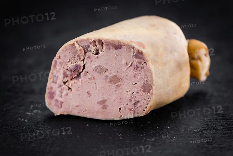 Portion of German Leberwurst as detailed close up shot on a slate slab (selective focus)