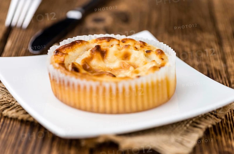 Fresh made Mini Cheesecake on an old and rustic wooden table (selective focus, close-up shot)
