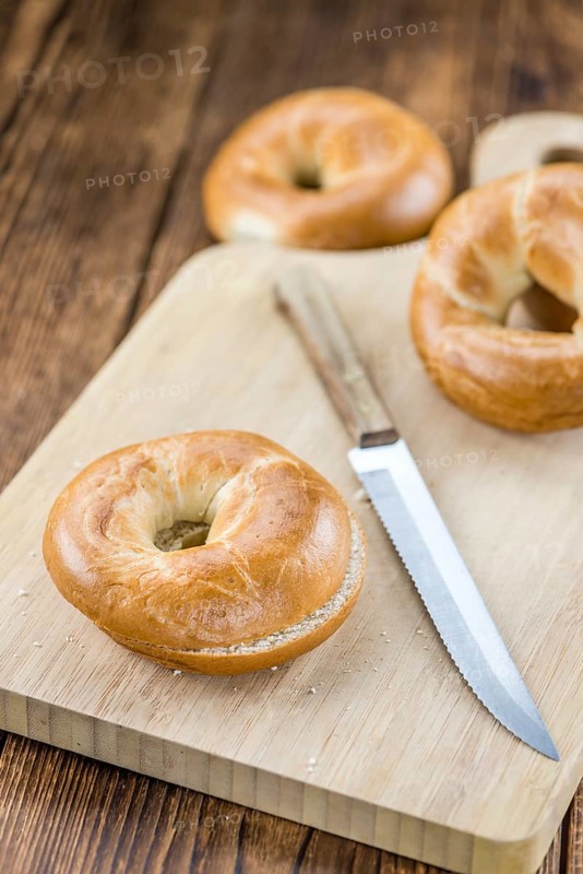 Fresh baked Bagels on a wooden table (selective focus, close-up shot)