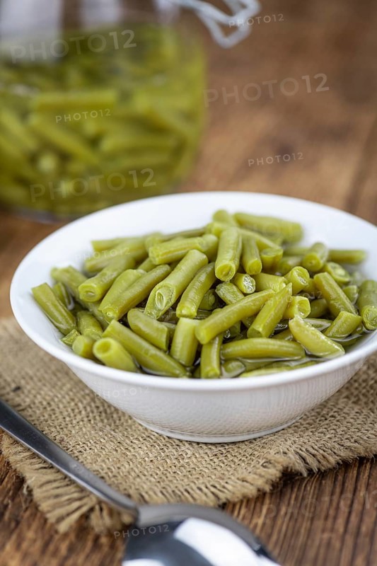 Preserved Green Beans as detailed close-up shot (selective focus) on vintage background