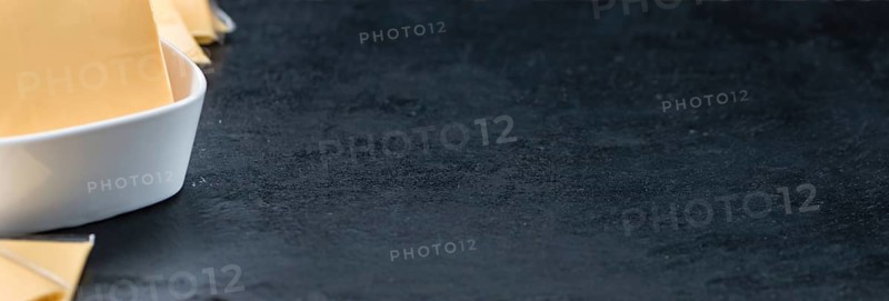 Sliced Cheese on a vintage background as detailed close-up shot (selective focus)