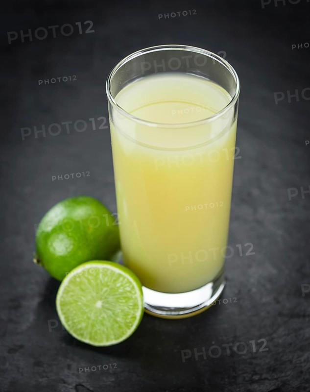 Some Fresh Lime Juice on a slate slab (close-up shot, selective focus)