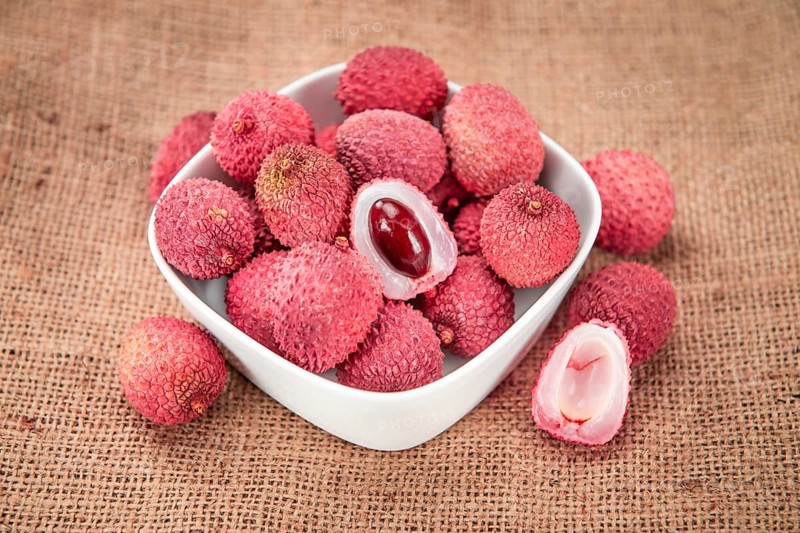 Lychees on a vintage background as detailed close-up shot (selective focus)