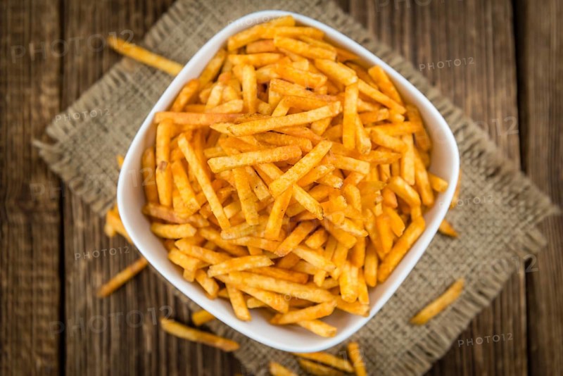 Potato Sticks (close-up shot, selective focus) on an old wooden table