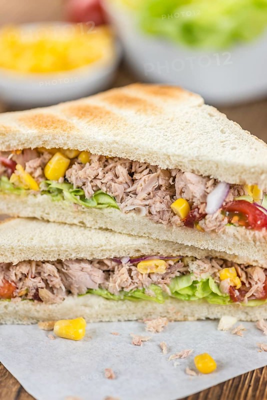 Homemade Tuna Sandwich (selective focus, close-up shot) on vintage wooden background