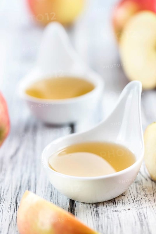 Portion of fresh made Applesauce (selective focus) on wooden background