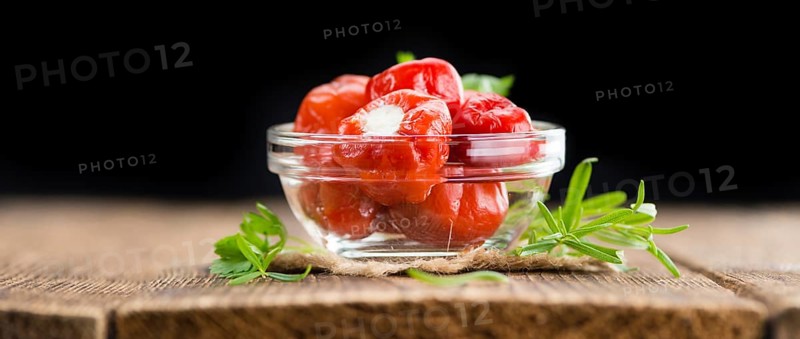 Homemade Filled Pimientos on vintage background (selective focus, close-up shot)