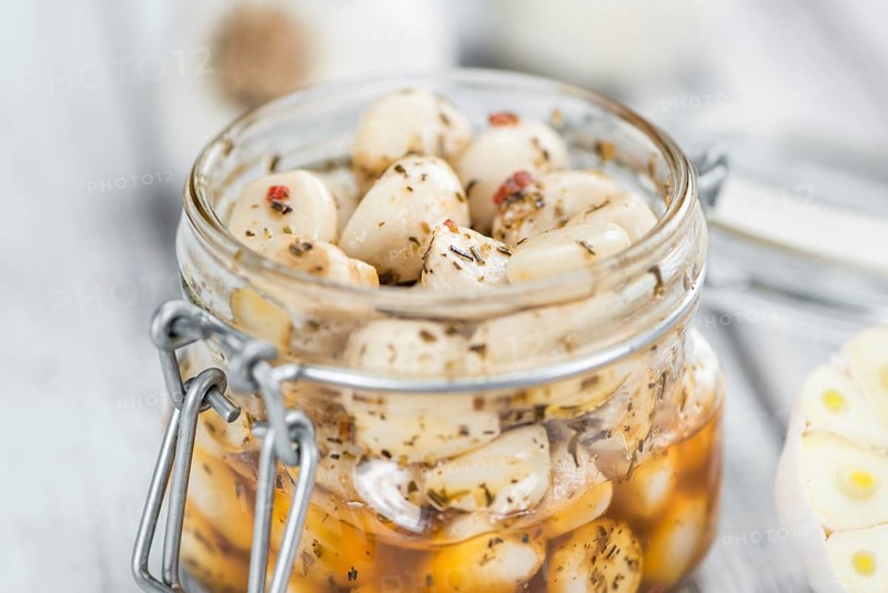 Portion of fresh Preserved Garlic (close-up shot, selective focus)