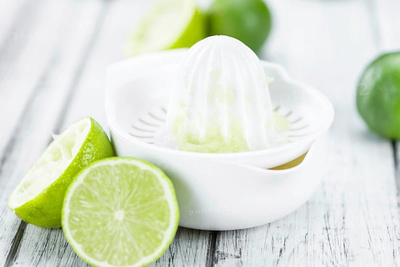 Portion of fresh Lime Juice (close-up shot, selective focus)