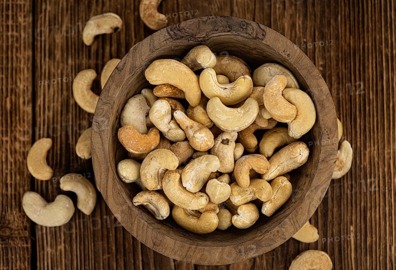 Portion of roasted Cashew Nuts (close up shot, selective focus)