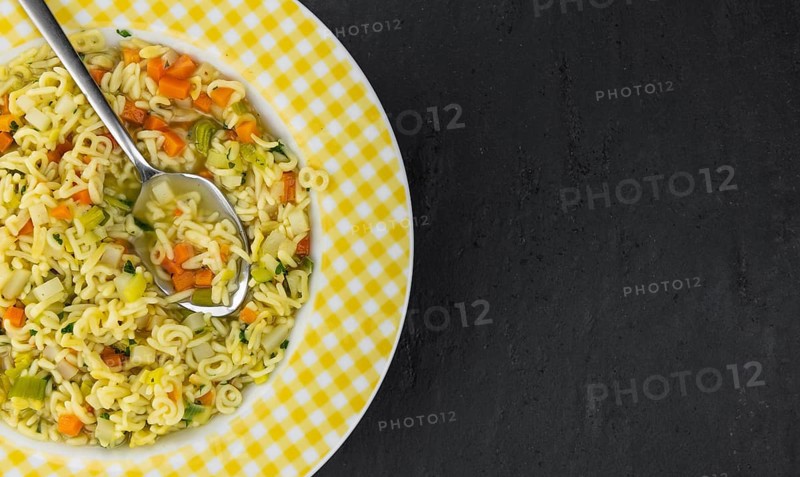 Portion of fresh made Alphabet Soup (selective focus, close-up shot)