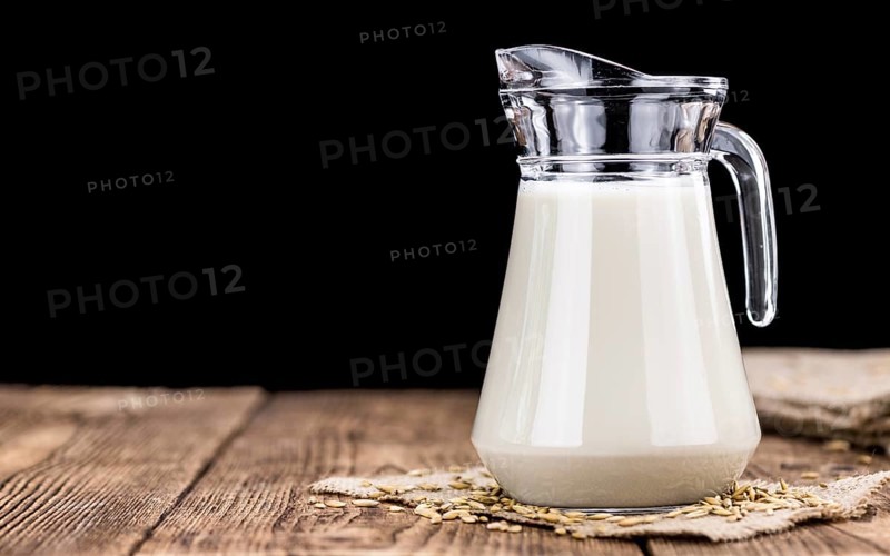 Wooden table with Oat Milk (detailed close-up shot, selective focus)