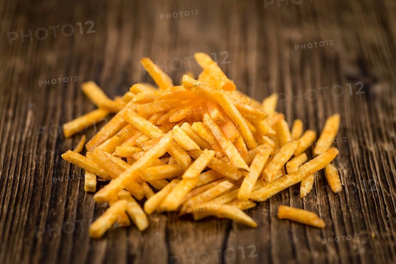 Portion of fried potato sticks (close-up shot, selective focus)