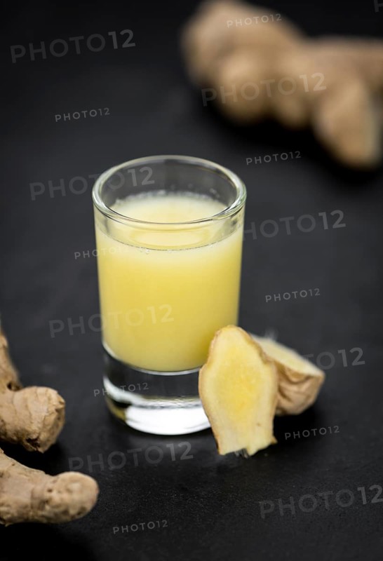 Fresh made Ginger Drink on a slate slab (close-up shot, selective focus)