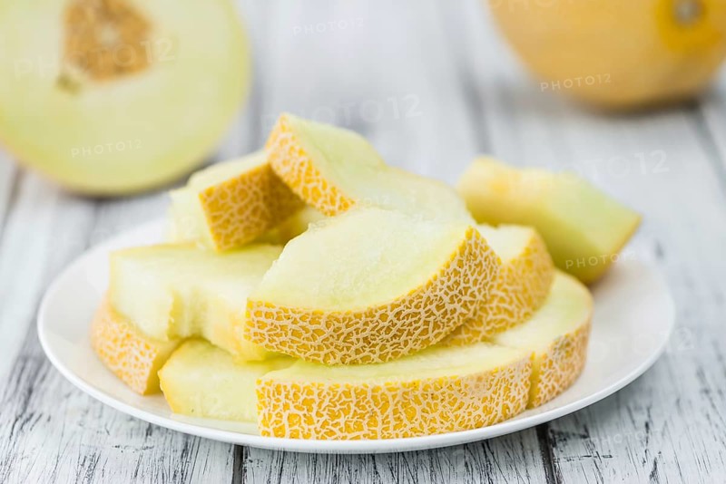 Honeydew Melon on a vintage background as detailed close-up shot (selective focus)