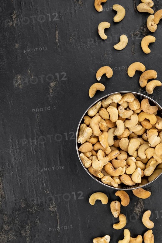 Portion of roasted Cashew Nuts (close up shot, selective focus)