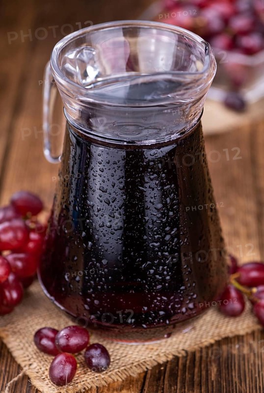 Fresh Red Grape Juice as detailed close-up shot (selective focus)