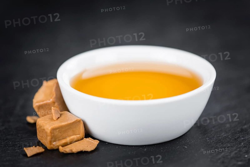 Syrup (Caramel taste) on a vintage slate slab (close-up shot, selective focus)