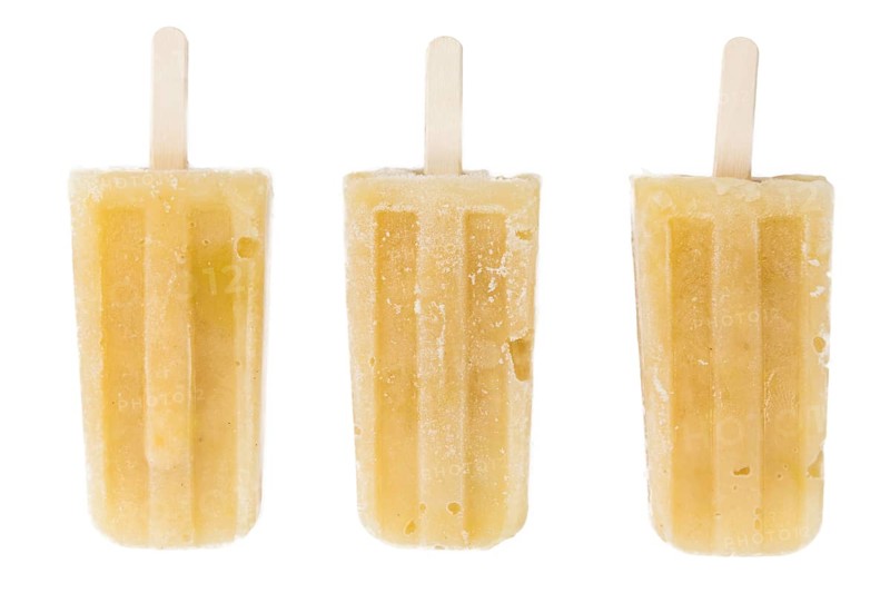 Fresh made Apple Popsicles (close-up shot) isolated on white background