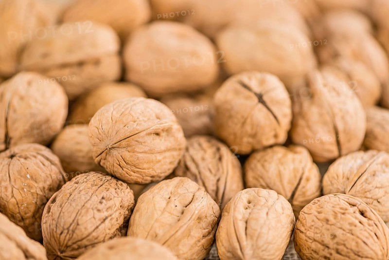 Walnuts on a vintage background as detailed close-up shot (selective focus)