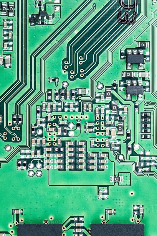 Green PCB (printed circuit board) close-up shot with a lot of electronic components