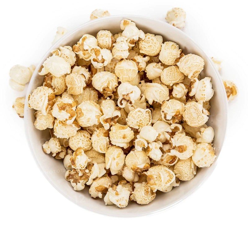 Portion of Popcorn as detailed close-up shot isolated on white background