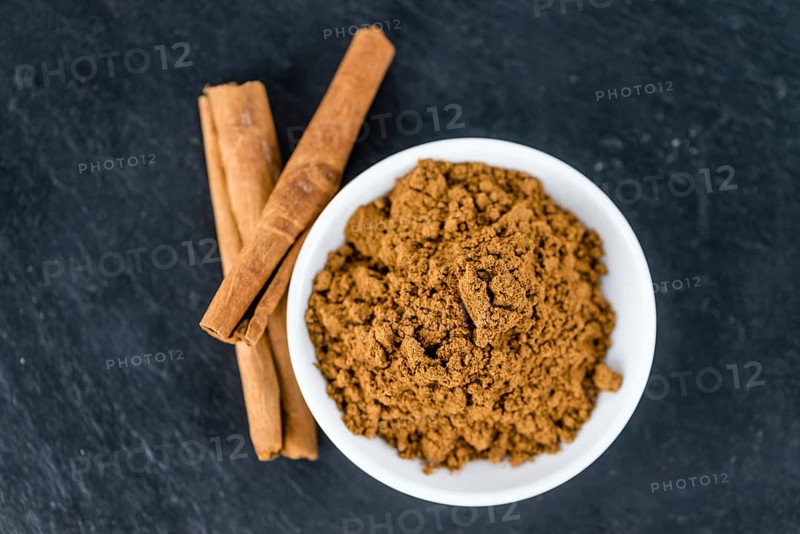 Fresh made Cinnamon Powder on a vintage background (close-up shot)