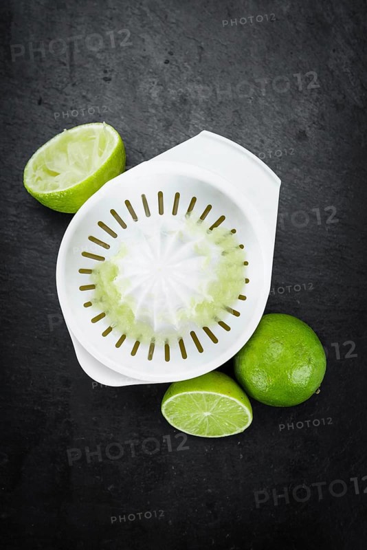 Some Fresh Lime Juice on a slate slab (close-up shot, selective focus)