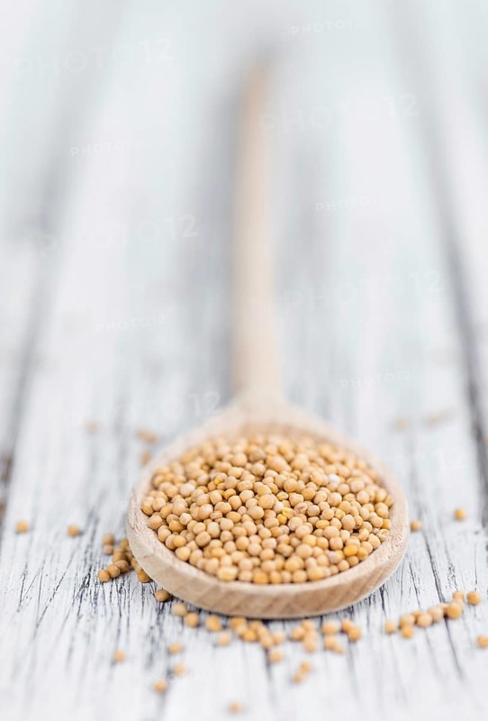 Mustard Seeds on a vintage background as detailed close-up shot (selective focus)