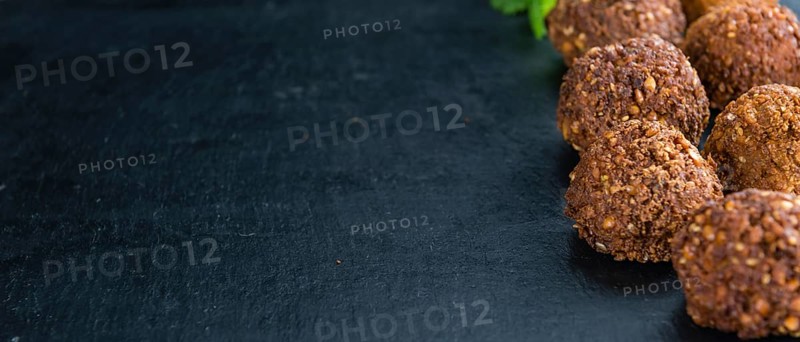 Wooden table with Falafels (close-up shot, selective focus)