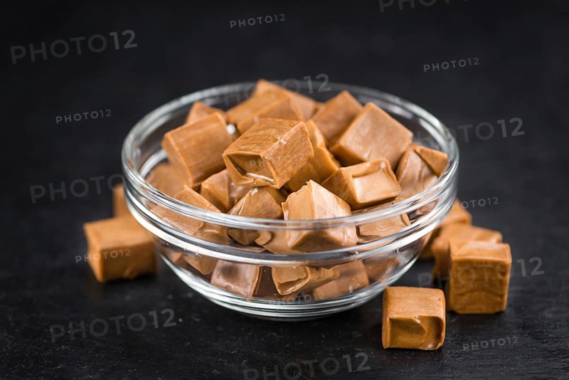 Caramel candy on a vintage slate slab (close-up shot, selective focus)