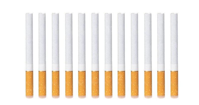 Row, group of filter cigarettes isolated on white background