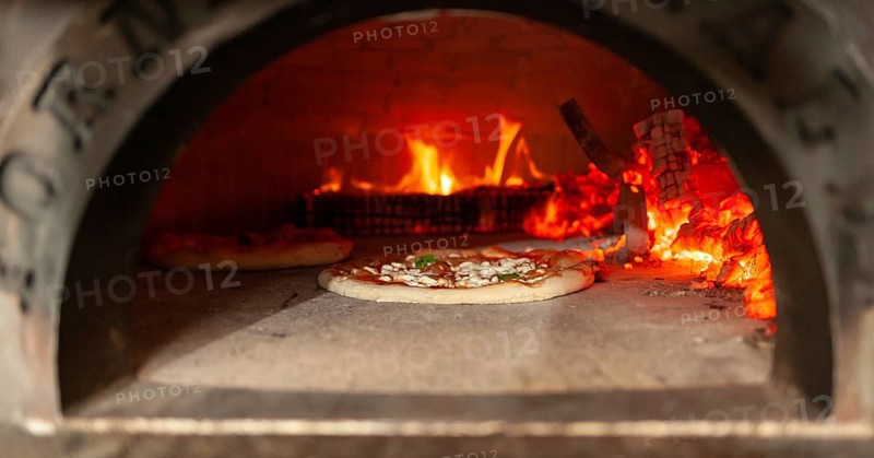 Cooking a margherita pizza in a wood oven