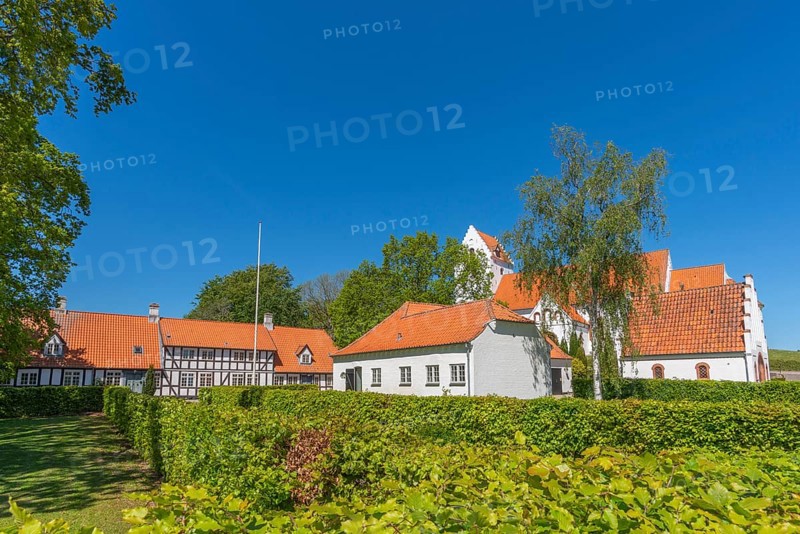 Lindelse Kirke, typical Danish church from 1830, whitewashed, red tiled roof, hill, pastorate, half-timbered house, hedge, trees, Rudkobing, Langeland Island, South Funen, Danish South Sea, Baltic Sea, Denmark, Europe