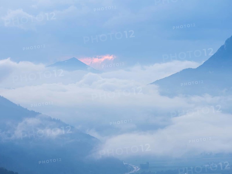 Evening clouds and fog over the Liesingtal, in the valley the village of Traboch, Schoberpass federal road, view from the lowlands, Leoben, Styria, Austria, Europe
