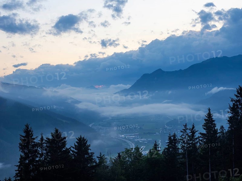 Evening clouds and fog over the Liesingtal, in the valley the village of Traboch, Schoberpass federal road, view from the lowlands, Leoben, Styria, Austria, Europe