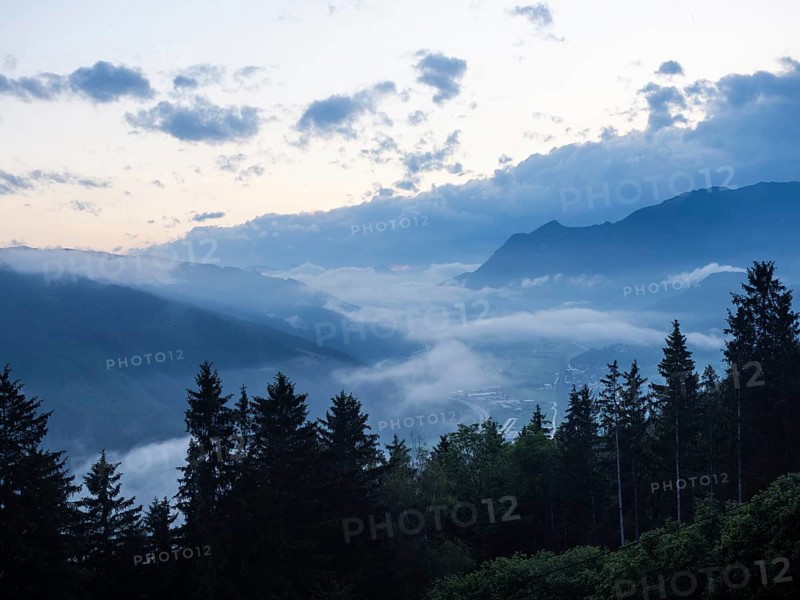 Evening clouds and fog over the Liesingtal, in the valley the village of Traboch, Schoberpass federal road, view from the lowlands, Leoben, Styria, Austria, Europe