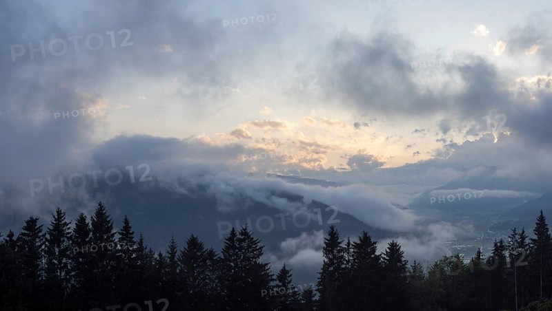 Evening clouds and fog over the Liesingtal, in the valley the village of Traboch, Schoberpass federal road, view from the lowlands, Leoben, Styria, Austria, Europe