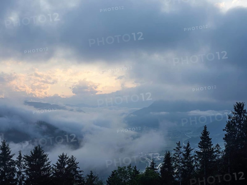 Evening clouds and fog over the Liesingtal, in the valley the village of Traboch, Schoberpass federal road, view from the lowlands, Leoben, Styria, Austria, Europe