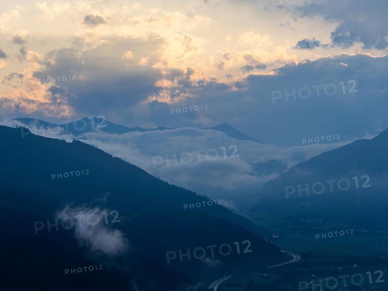 Evening clouds and fog over the Liesingtal, in the valley the village of Traboch, Schoberpass federal road, view from the lowlands, Leoben, Styria, Austria, Europe