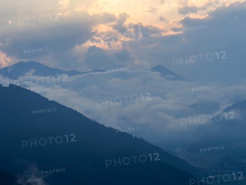 Evening clouds and fog over the Liesingtal, in the valley the village of Traboch, Schoberpass federal road, view from the lowlands, Leoben, Styria, Austria, Europe