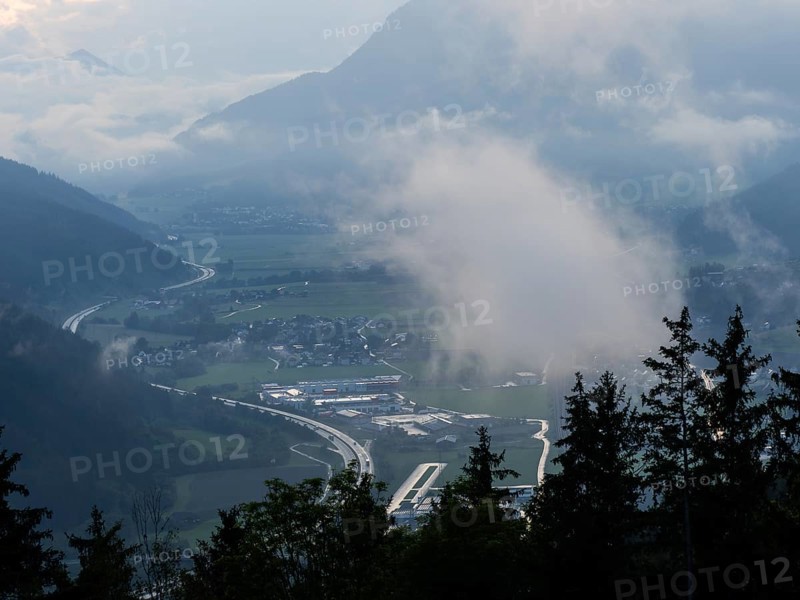 Evening clouds and fog over the Liesingtal, in the valley the village of Traboch, Schoberpass federal road, view from the lowlands, Leoben, Styria, Austria, Europe