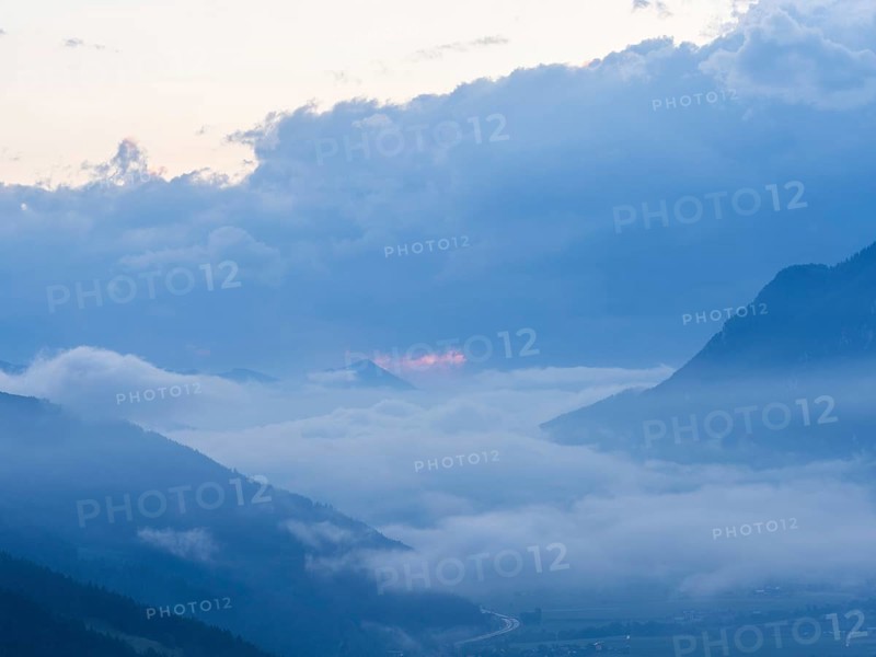 Evening clouds and fog over the Liesingtal, in the valley the village of Traboch, Schoberpass federal road, view from the lowlands, Leoben, Styria, Austria, Europe