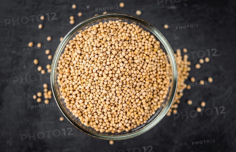 Portion of fresh made Mustard Seeds (close-up shot, selective focus)