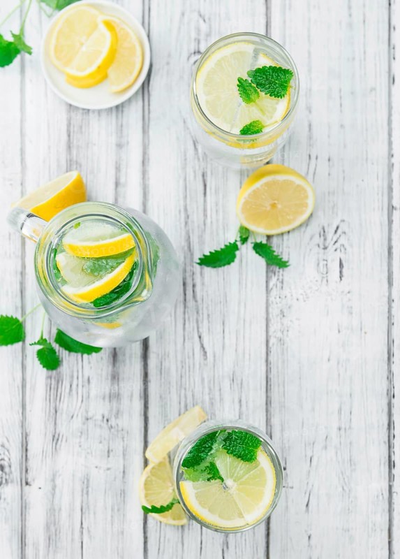 Homemade Lemonade on an wooden table (selective focus) as detailed close-up shot