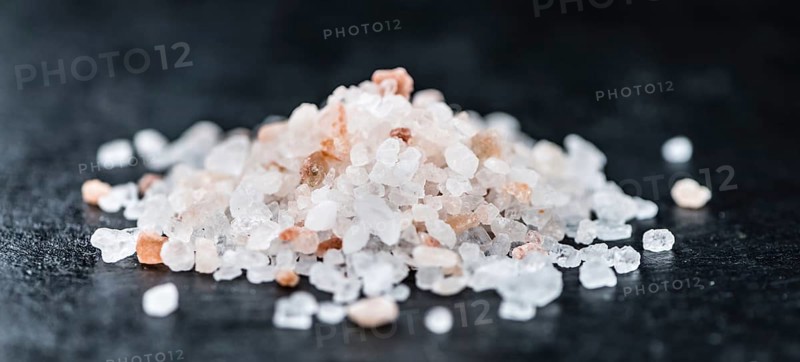 Pink Salt on a vintage background as detailed close-up shot (selective focus)