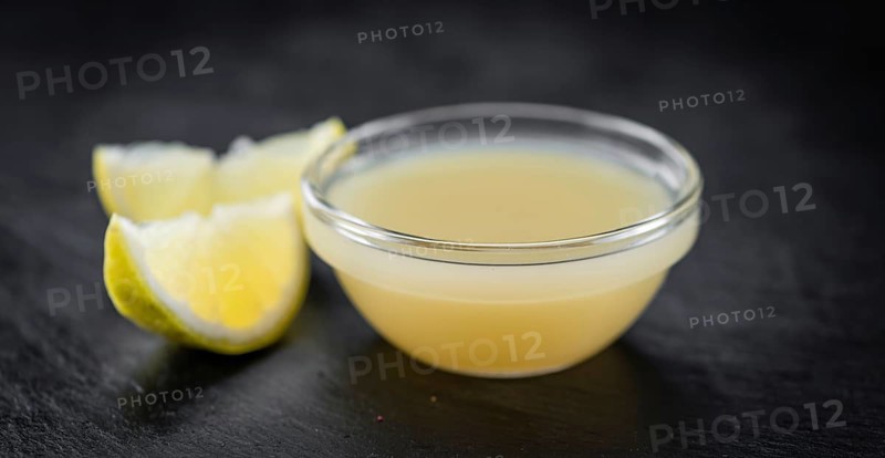 Some Juice (lemon) on a slate slab (close-up shot, selective focus)