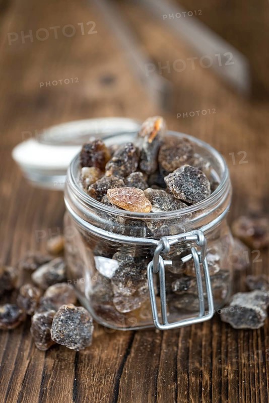 Brown Rock Candy on wooden background (selective focus, close-up shot)
