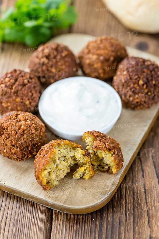 Portion of Falafel on an old wooden table (close-up shot, selective focus)