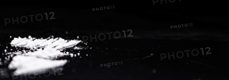 Dark plate with a portion of Cocaine as close-up shot